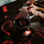 Gracze przy klawiaturach mechanicznych podczas intensywnej rozgrywki